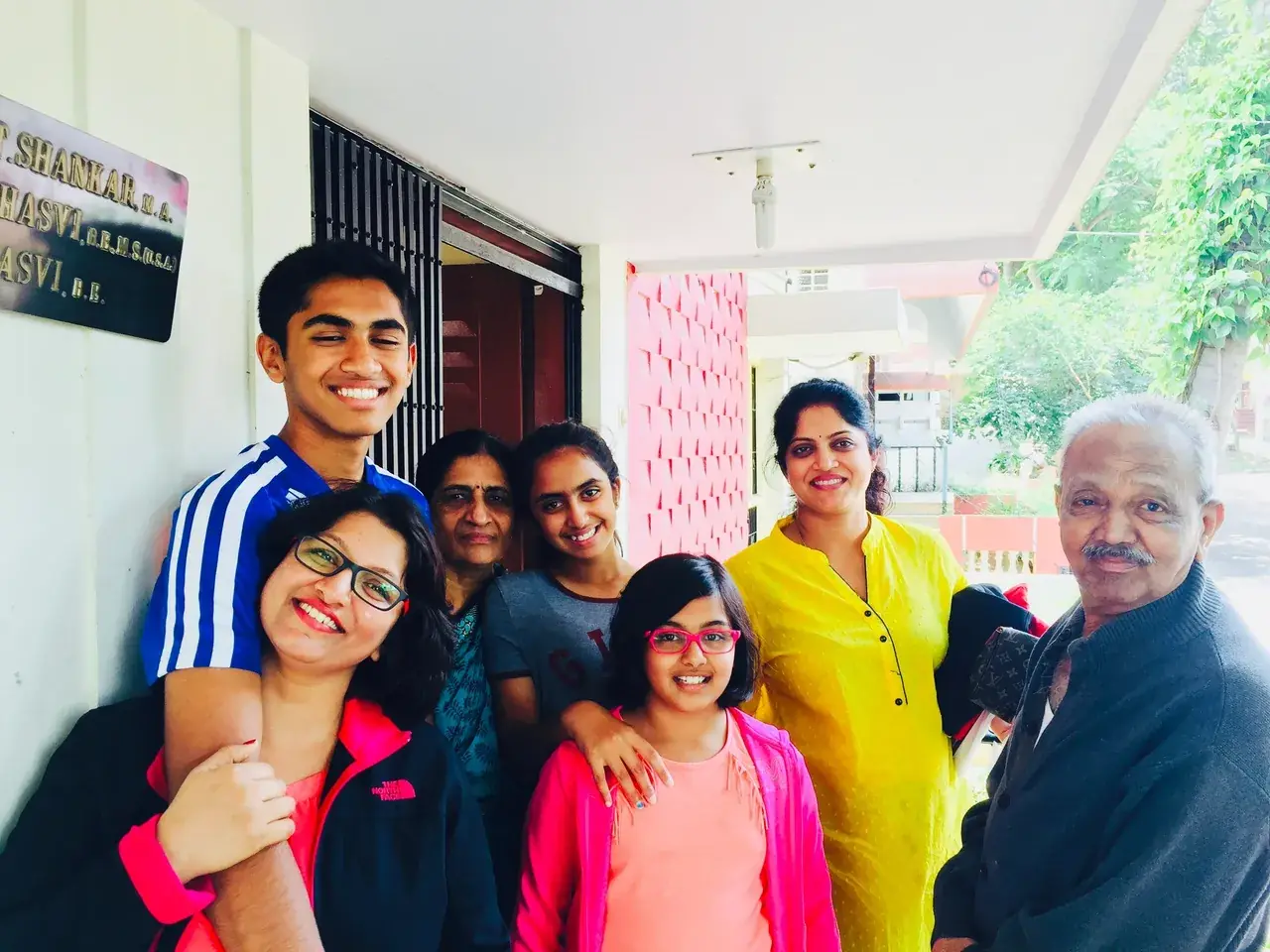 The family gathered at the doorstep of the family home