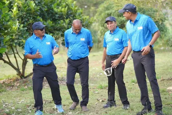 Tigers players discussing strategy on the fairway