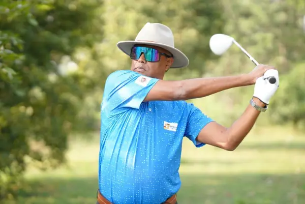 Tigers player in a wide-brim hat driving off the tee